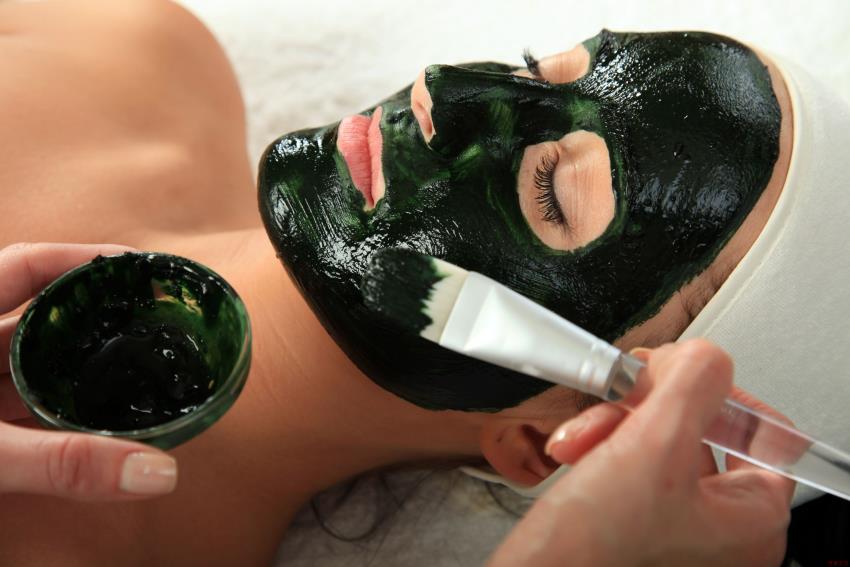 Woman receiving a facial spa treatment