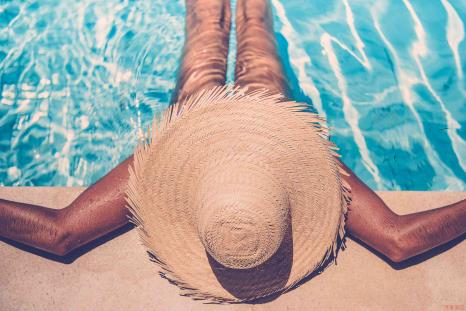 Woman suntanning in a pool