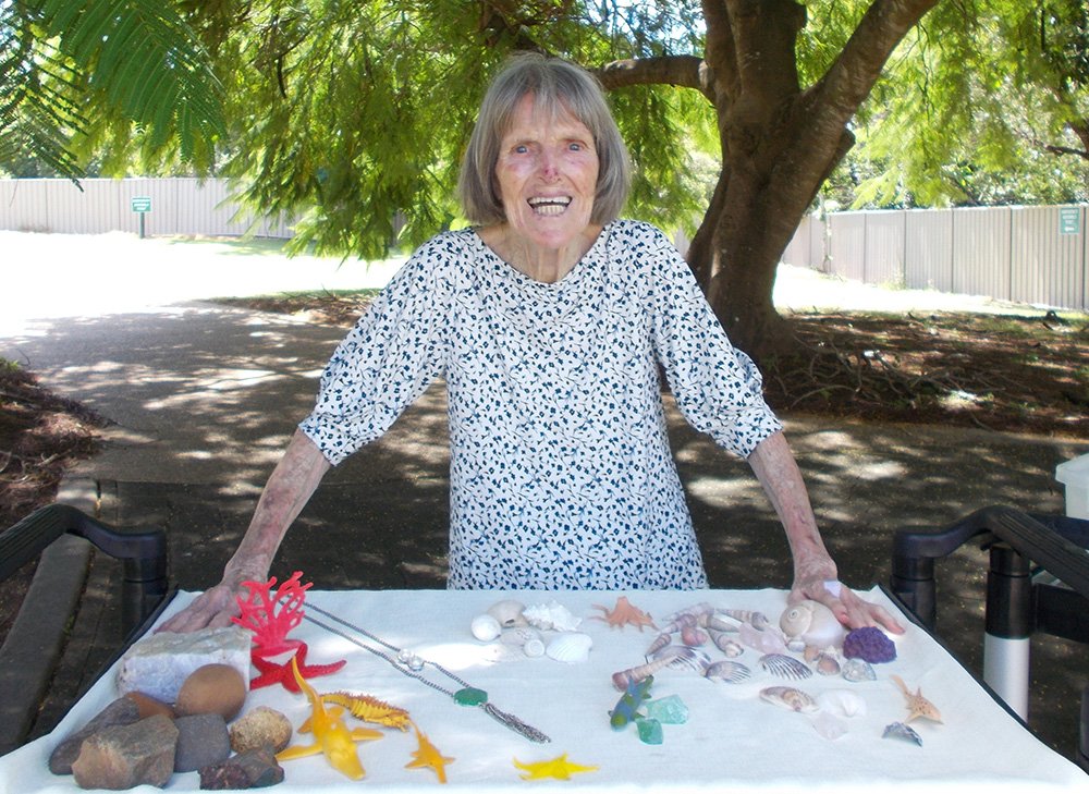 Carinity Kepnock Grove aged care resident Maureen Irwin with items collected during a beach combing sensory activity