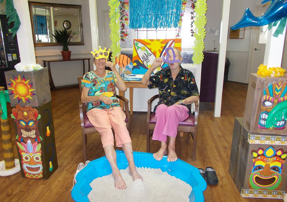 Residents Judy and Tony Rollitt enjoy a beach-themed event at Carinity Kepnock Grove aged care in Bundaberg