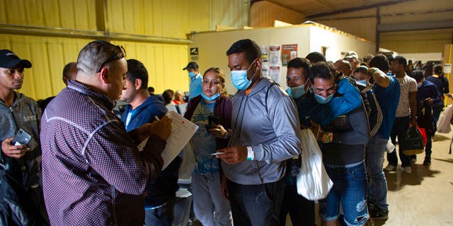 May 23, 2022: People line up for a commercial bus that will take them to the San Anto<em></em>nio airport at a warehouse run by the Mission: Border Hope no<em></em>nprofit group run by the United Methodist Church in Eagle Pass, Texas. 