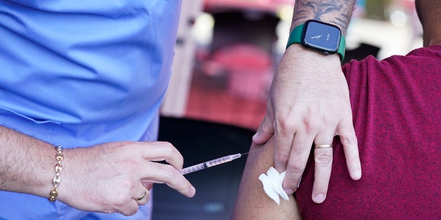 FILE - A nurse administers a mo<em></em>nkeypox vaccine at a walk-in clinic at the North Jersey Community Research Initiative in Newark, N.J., Tuesday, Aug. 16, 2022.
