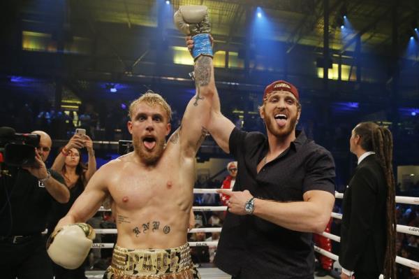 Jake Paul celebrates with his brother, Logan, after defeating AnEso<em></em>nGib 